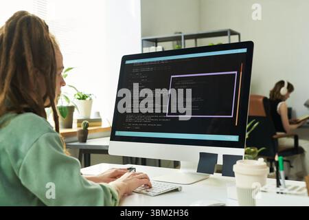 Young Adult Caucasian Woman Developing Neural Network on Desktop Computer Stock Photo