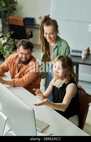 Young Caucasian Woman Explaining Neural Network Development to Diverse Team Stock Photo