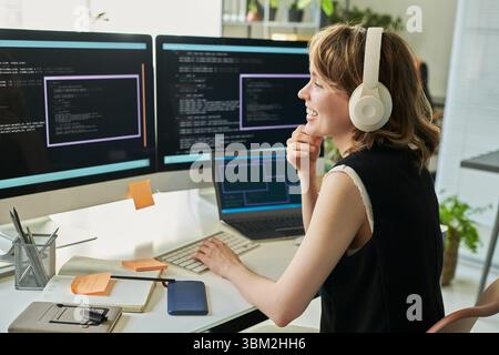 Caucasian Young Adult Woman Developing Neural Network on Computer Monitors Stock Photo
