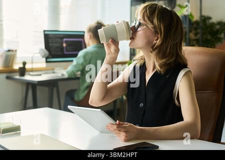 Young Caucasian Woman Developing Neural Network While Drinking Coffee Stock Photo