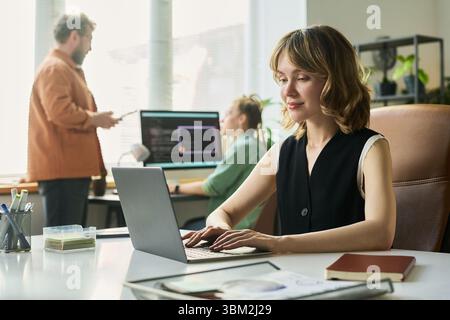 Young Adult Caucasian Woman Collaborating on Neural Network Project with Team Stock Photo