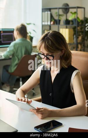 Young Caucasian Woman Using Digital Tablet While Developing Neural Network Model Stock Photo