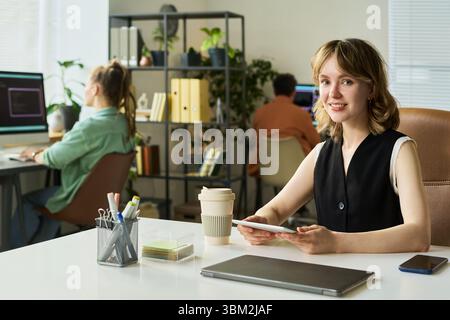 Portrait of Young Adult Caucasian Woman Smiling in Office Stock Photo