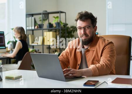 Portrait of Young Adult Caucasian Man Working on Neural Network Project Indoors Stock Photo