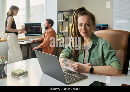 Portrait of Young Adult Caucasian Woman Developing Neural Network at Office Desk Stock Photo