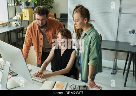 Young Adult Multiethnic Team Collaborating on Neural Network Interface Design Stock Photo