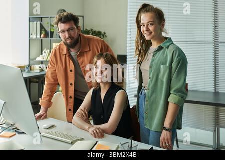 Young Caucasian Man and Two Young Caucasian Women Developing Neural Network Stock Photo
