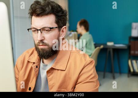 Caucasian Young Adult Man Developing Neural Network on Computer in Office Stock Photo