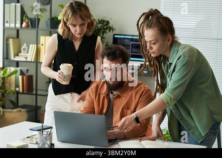 Young Adult Multiethnic Team Collaborating on Neural Network Development Project Stock Photo