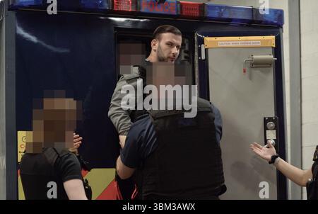 EDITORS NOTE: Image blurred at source. Undated handout photo issued by the Metropolitan Police of James Harding being arrested by officers from the Metropolitan Police following his extradition from Switzerland. A pair of drug kingpins are facing jail for plotting to murder a rival and smuggling millions of pounds worth of cocaine into the UK following one of the largest EncroChat investigations in history. James Harding, 34, and his 'loyal right-hand man' Jayes Kharouti, 39, ran a vast criminal empire which made £5 million in profits from importing drugs over 10 weeks in 2020 alone. Issue dat Stock Photo