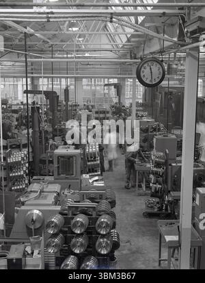 1950s, historical, engineering factory, workers at lathes producing metal parts for the aviation industry. Seen in the picture, an EltroPilot operator panel, electronic tools used in lathe turning machines for pre-set metalworking. Stock Photo