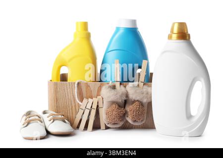 Bottles with fabric softener, basket, shoes and clothespins isolated on white Stock Photo