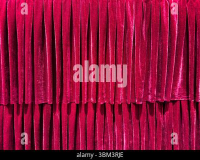 Red velvet curtain backdrop on a theater stage. Closed luxury drapes background Stock Photo