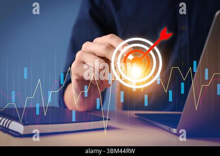 Targeting. Businessman touching aim with arrow on virtual screen at table, closeup Stock Photo