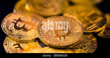 Abstract closeup of Bitcoin gold coins, soft light reflections, cryptocurrency concept, digital finance background, financial investment technology Stock Photo