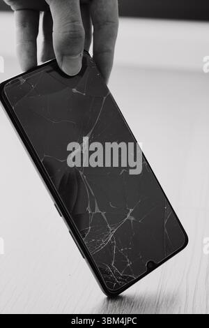 Broken cell phone screen after falling on the floor Stock Photo