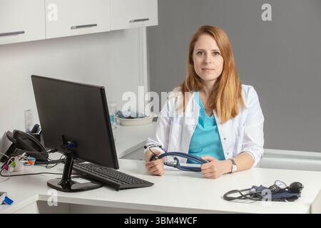Female medicine doctor sitting and working at her office. Healthcare and medical concept.Doctor in white coat doing paperwork at work and study tests. Stock Photo