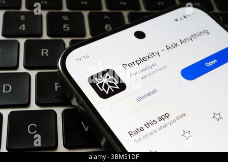 Perplexity AI mobile interface displayed on smartphone over keyboard with install options visible. Stafford, United Kingdom, June 24, 2025 Stock Photo