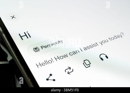 Perplexity assistant responds with greeting on white mobile interface screen. Stafford, United Kingdom, June 24, 2025 Stock Photo