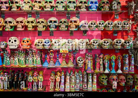 Mexico, Merida. Colorful display of Day of the Dead ceramic skulls and traditional Mexican skeleton figurines in a souvenir shop. (Editorial Use Only) Stock Photo