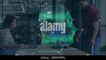 Projecting hologram head showing data nodes and camera icons above conference table, with laptops. Technology, innovation, data, collaboration, digita Stock Photo