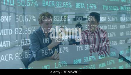 Reviewing data on laptop two professionals collaborating in open office, with stock ticker graphics. Collaboration, teamwork, modernity, dataanalytics Stock Photo