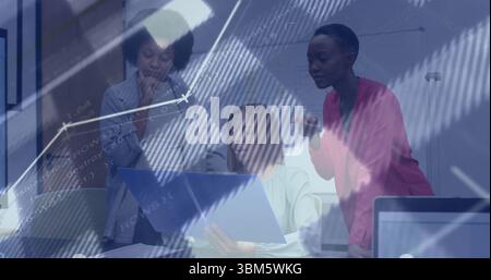 Reviewing three businesswomen in blazers at meeting table, with blue binder and code overlay. Corporate, teamwork, collaboration, professional, modern Stock Photo