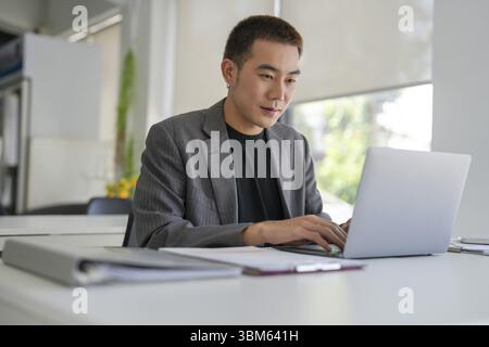 Business man working using laptop computer Hands typing keyboard. Professional investor working start up project. business planning in office. Technol Stock Photo