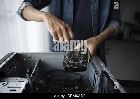 IT Engineer installing Hardware Equipment Development Facility Engineer Maintenance computer Motherboard Electronic repair shop technology business Stock Photo