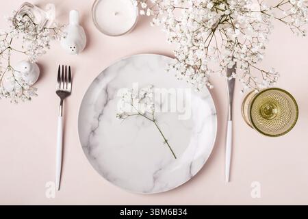 Romantic table setting in pink colors. White flowers decor Stock Photo