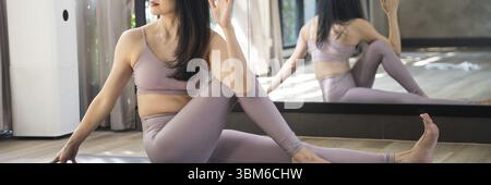 Female happiness Attractive young asian woman doing yoga stretching exercise on mat yoga & fitness exercises. Healthy lifestyle Calmness and relax Stock Photo