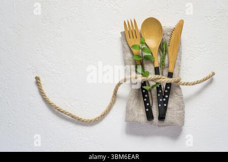 Set of bamboo cutlery and napkin on a white background. Natural table setting Stock Photo