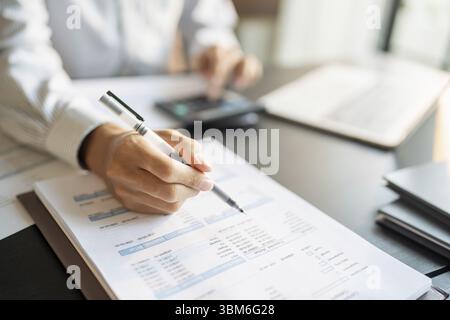 Close up of businessman hands signing or writing document paperwork and report Auditor analysis male professional hand making notes with Business Docu Stock Photo