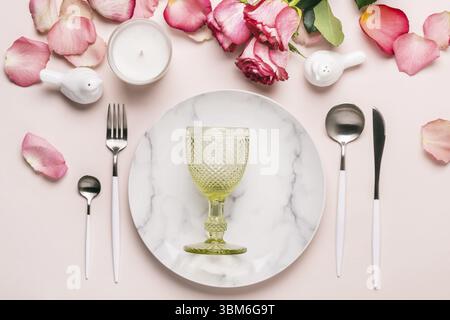 Romantic table setting in pink colors. Tableware and decorations for serving a festive table Stock Photo