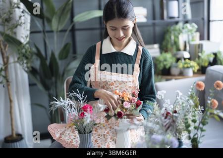 Happy asian female florist Startup small business successful SME in flowers shop Stock Photo
