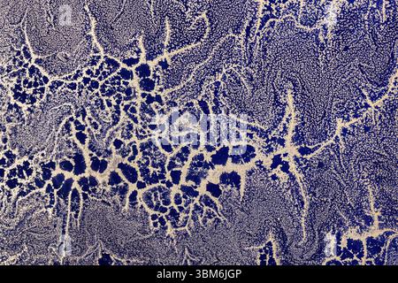 Acrylic Fluid Art. Gold sparkles wavy pattern on dark blue background. Abstract background or texture Stock Photo