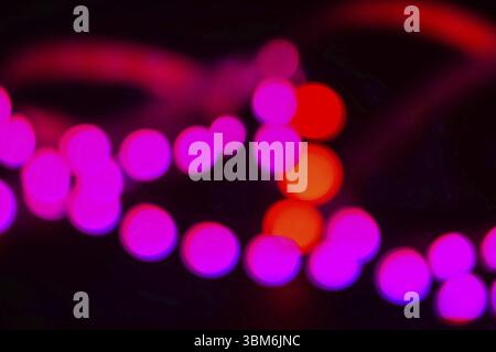 Duotone Red and purple neon lights on black. Abstract blurred background Stock Photo