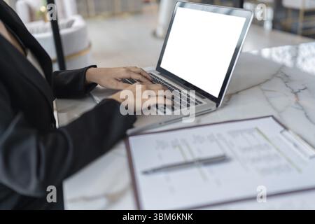 Beautiful Business Woman working by using laptop computer Hands typing on keyboard. Professional investor working new start up project. business plann Stock Photo