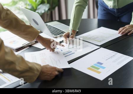 Team leader coach teach young workers explain on paper for business plan listen talkative coworker and discussing new project presentation Serious pro Stock Photo