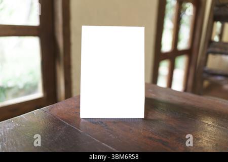 Menu mock up blank for text marketing promotion. Mock up Menu frame standing on wood table in restaurant space for text Stock Photo