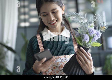Happy asian female florist Startup small business successful SME in flowers shop Stock Photo
