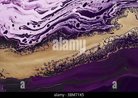Fluid Art. Metallic gold abstraction and purple waves. Marble effect background or texture Stock Photo