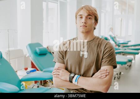 Portrait of Young Adult Caucasian Man Standing in Blood Donation Center Stock Photo
