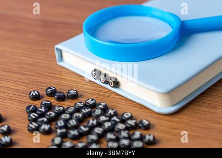 Alphabet beads spelling "SEO" with more scattered beads on a wooden table. Digital marketing, data analysis, and information discovery concept. Stock Photo