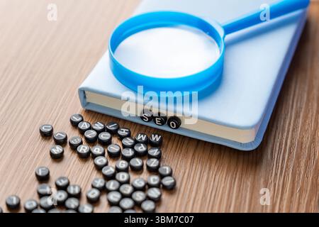 Alphabet beads spelling "SEO" with more scattered beads on a wooden table. Digital marketing, data analysis, and information discovery concept. Stock Photo