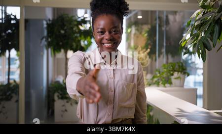 African American business woman friendly gesture extend hand greeting candidate hiring in office company smiling girl female businesswoman employer HR Stock Photo