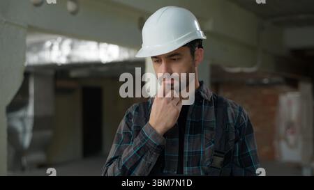 Man inspector builder holding measure ruler male repairman Caucasian guy on construction site measuring building professional architect contractor Stock Photo