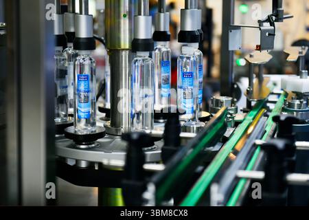 Bangkok, Thailand-June13,2025: Plastic bottles in a conveyor belt on a high quality automatic vertical filling machine in Propak asia at Bitec Exhibit Stock Photo