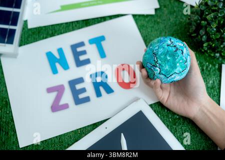Close-up of businessman's hands gently holding globe, symbolizing eco-conscious business and global care. Stock Photo