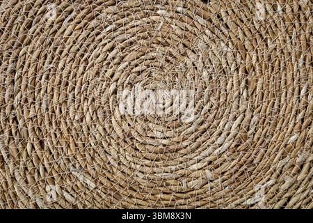 Intricate spiral straw natural texture background Stock Photo